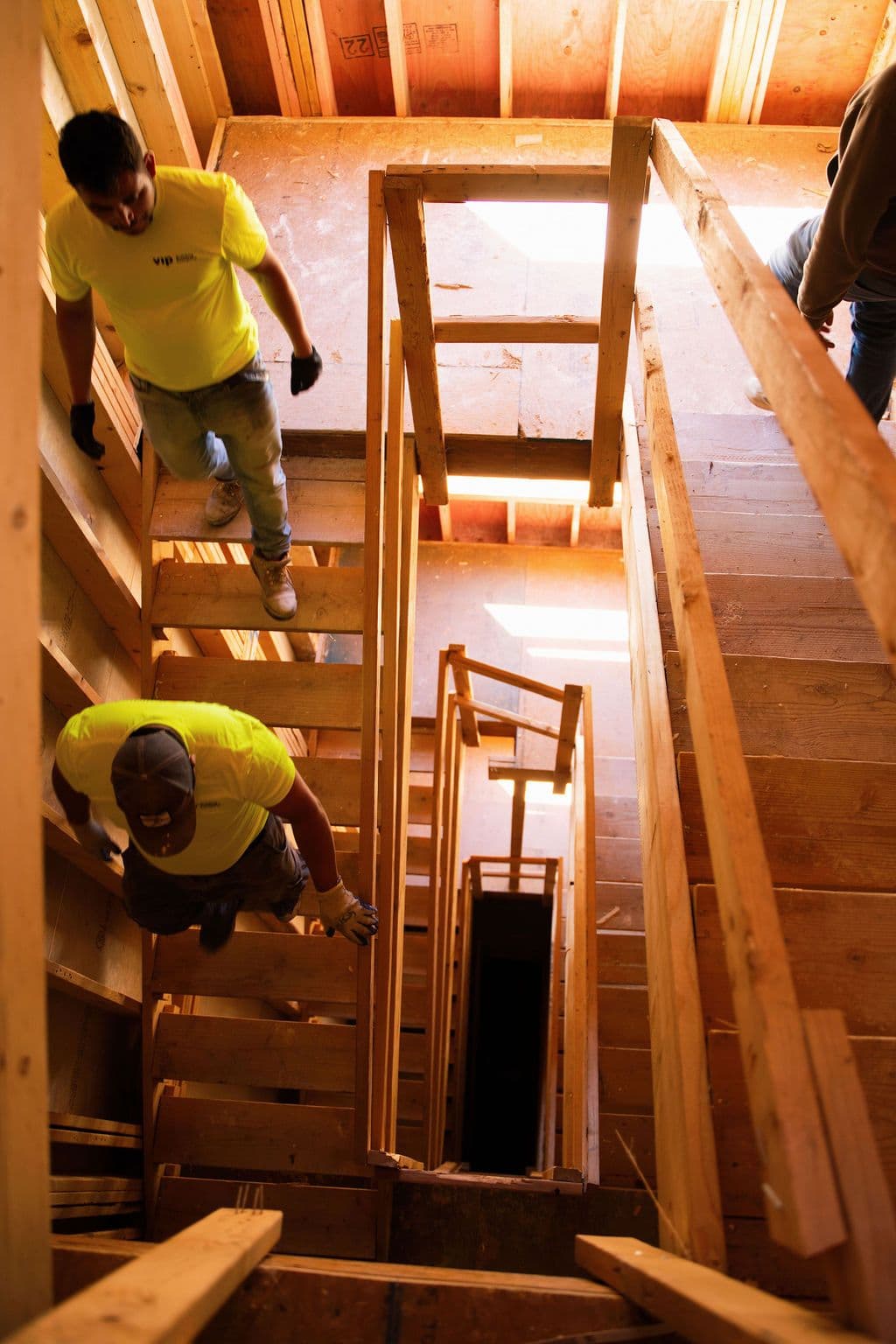 A construction site with a scaffold and two managers pointing.